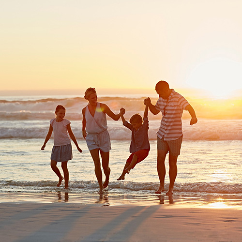 family-beach-sunset_500px family of four playing on the beach at sunset