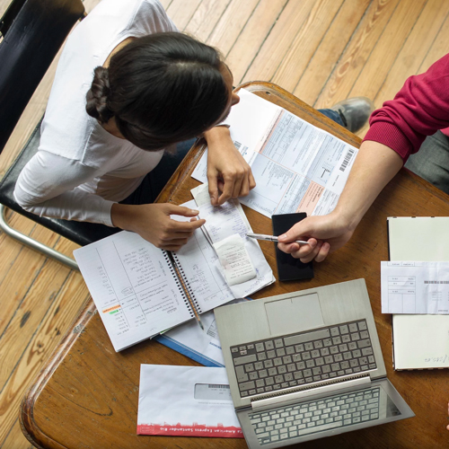 working-overhead-view_500px Overhead view of two people sitting at a table with a laptop and business papers